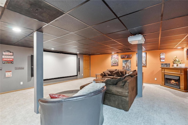 219 Cypress St, Park Hills, MO 63601 - home theater room featuring carpet flooring, a lit fireplace, baseboards, and a paneled ceiling