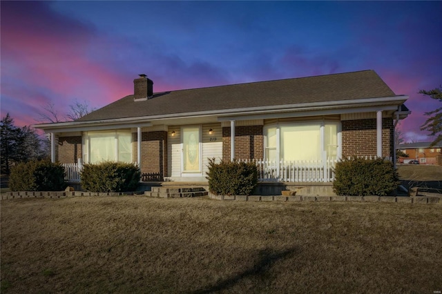 219 Cypress St, Park Hills, MO 63601 - view of front facade with brick siding, a chimney, and a porch