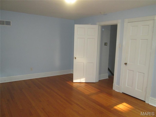 7939 Delmar Blvd Unit 1W, Saint Louis, MO 63130 - unfurnished bedroom featuring wood finished floors and baseboards