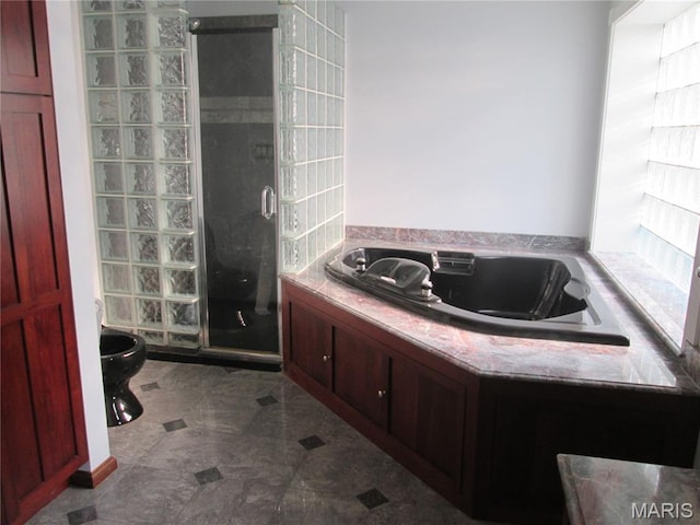 7939 Delmar Blvd Unit 1W, Saint Louis, MO 63130 - full bathroom featuring a shower stall, a garden tub, and toilet