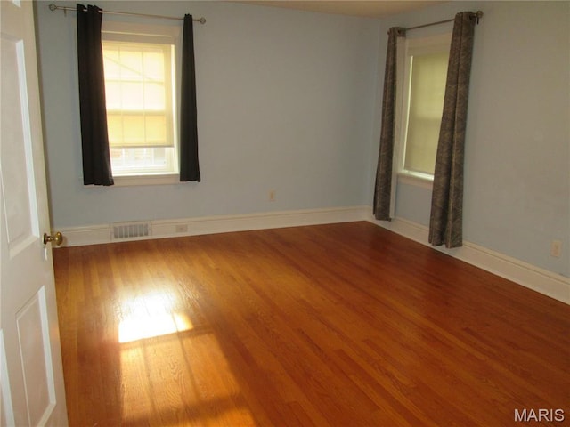 7939 Delmar Blvd Unit 1W, Saint Louis, MO 63130 - empty room with wood finished floors and baseboards