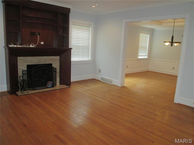 7939 Delmar Blvd Unit 1W, Saint Louis, MO 63130 - unfurnished living room with ornamental molding, wood finished floors, a fireplace, and baseboards