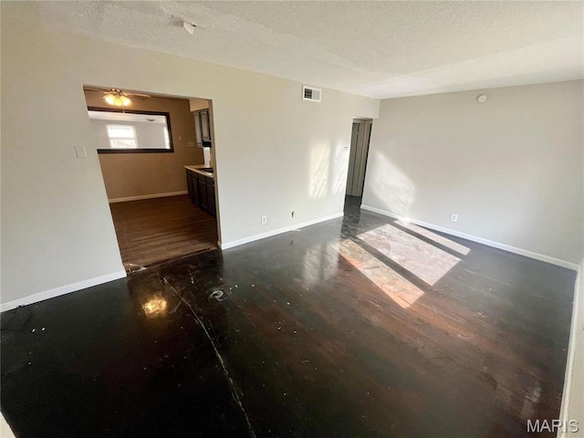 1117 Redman Blvd, Saint Louis, MO 63138 - unfurnished room with dark wood finished floors, a textured ceiling, and baseboards
