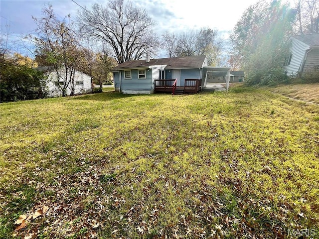 1117 Redman Blvd, Saint Louis, MO 63138 - back of house with a deck, a lawn, a chimney, and an attached carport