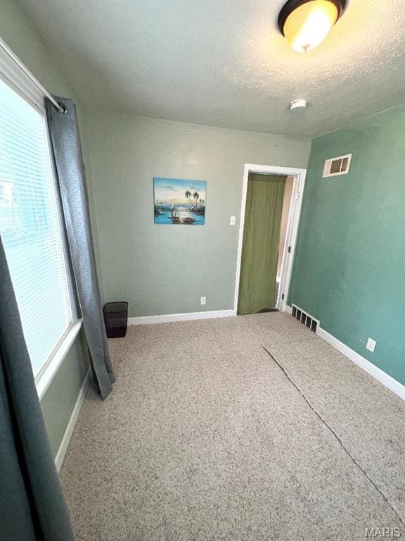 6746 Vernon Ave, University City, MO 63130 - carpeted empty room featuring baseboards and a textured ceiling