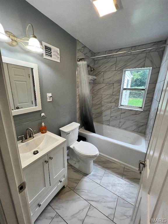 6746 Vernon Ave, University City, MO 63130 - full bath featuring marble look tiles, shower / bath combo with shower curtain, vanity, and toilet