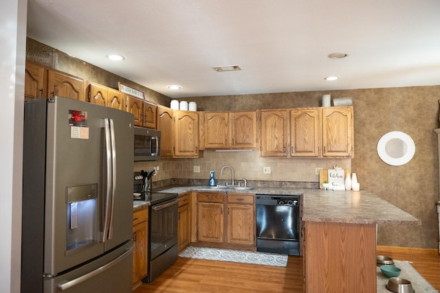 12332 Triple E Ln, Berger, MO 63014 - kitchen with black appliances, a sink, a peninsula, light wood-style flooring, and brown cabinets