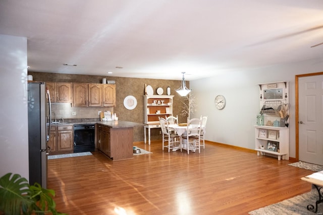 12332 Triple E Ln, Berger, MO 63014 - kitchen with dishwasher, a peninsula, light wood-type flooring, brown cabinetry, and freestanding refrigerator
