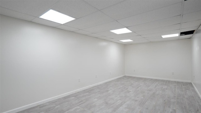 26380 Pebble Creek Dr, Warrenton, MO 63383 - spare room featuring a paneled ceiling, light wood-style flooring, and baseboards