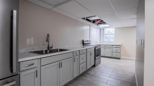 26380 Pebble Creek Dr, Warrenton, MO 63383 - kitchen with stainless steel range with electric cooktop, a sink, refrigerator, a paneled ceiling, and gray cabinetry