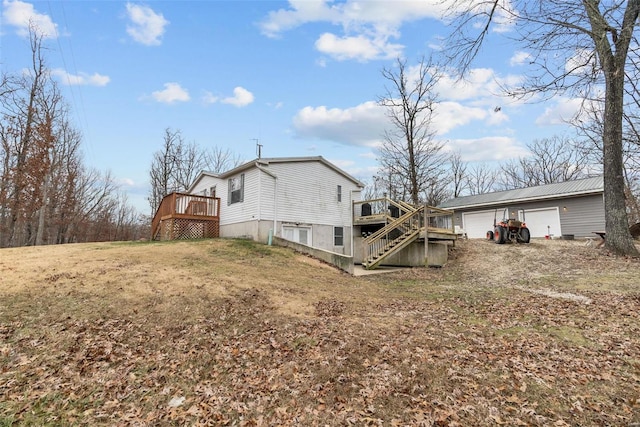 26380 Pebble Creek Dr, Warrenton, MO 63383 - rear view of house featuring a wooden deck, stairway, and a garage