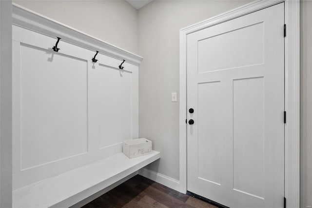mudroom featuring dark wood finished floors and baseboards
