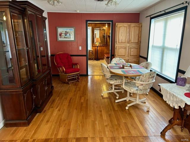 1028 Main St, New Madrid, MO 63869 - dining area with healthy amount of natural light, crown molding, and light wood-style flooring