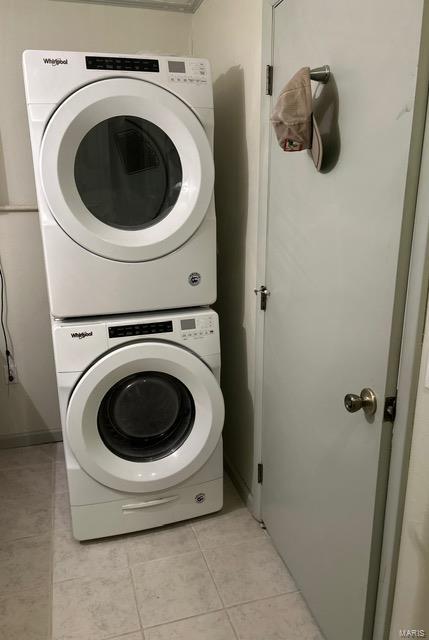 1028 Main St, New Madrid, MO 63869 - clothes washing area with stacked washer / dryer and light tile patterned flooring