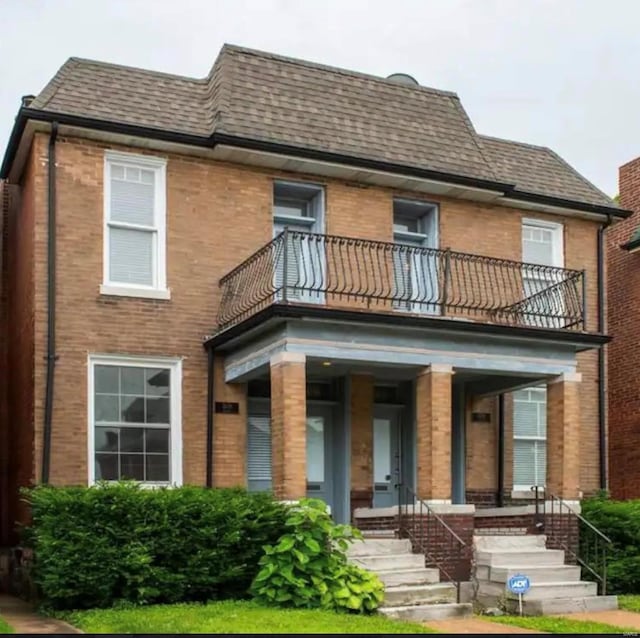 3636 Blaine Ave, Saint Louis, MO 63110 - view of front of home featuring a balcony, brick siding, roof with shingles, and mansard roof