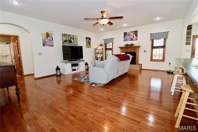 18921 Pleasant View Ln, Lebanon, MO 65536 - living area with ceiling fan, wood-type flooring, a fireplace with raised hearth, recessed lighting, and baseboards