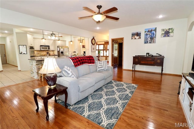 18921 Pleasant View Ln, Lebanon, MO 65536 - living room with a ceiling fan, light wood-style flooring, and baseboards