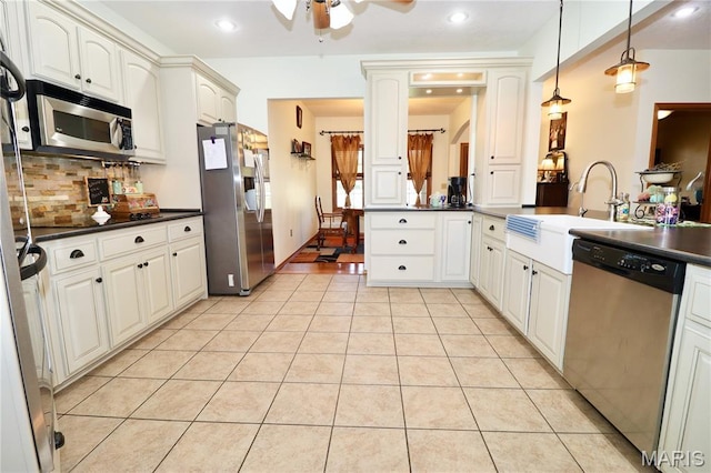 18921 Pleasant View Ln, Lebanon, MO 65536 - kitchen featuring appliances with stainless steel finishes, dark countertops, a ceiling fan, a sink, and recessed lighting