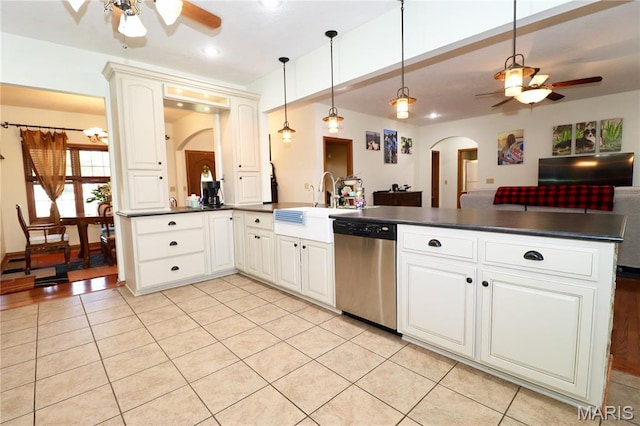 18921 Pleasant View Ln, Lebanon, MO 65536 - kitchen featuring stainless steel dishwasher, ceiling fan, dark countertops, arched walkways, and recessed lighting
