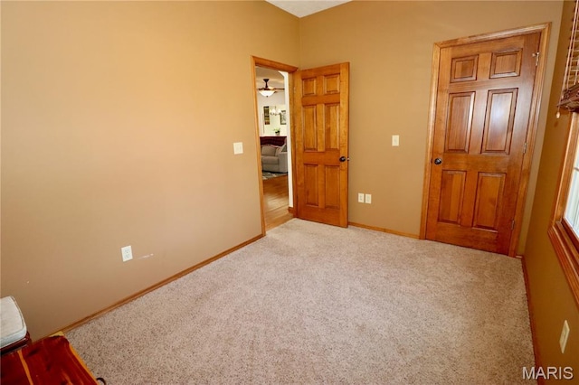 18921 Pleasant View Ln, Lebanon, MO 65536 - spare room featuring light colored carpet, baseboards, and ceiling fan