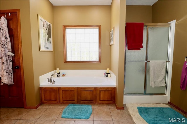 18921 Pleasant View Ln, Lebanon, MO 65536 - full bathroom featuring a stall shower, a bath, tile patterned floors, and baseboards