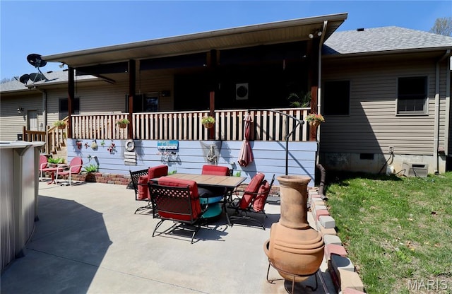 18921 Pleasant View Ln, Lebanon, MO 65536 - back of property with a shingled roof, a lawn, a patio, outdoor dining space, and crawl space