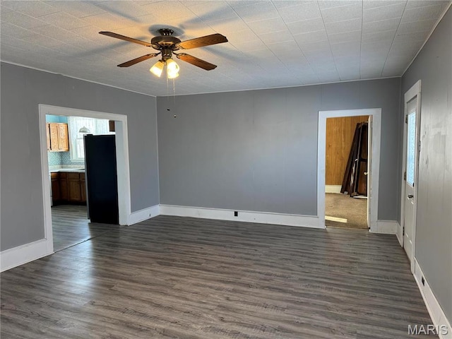 801 W Rolla Rd, Salem, MO 65560 - unfurnished room featuring dark wood-type flooring, ceiling fan, and baseboards