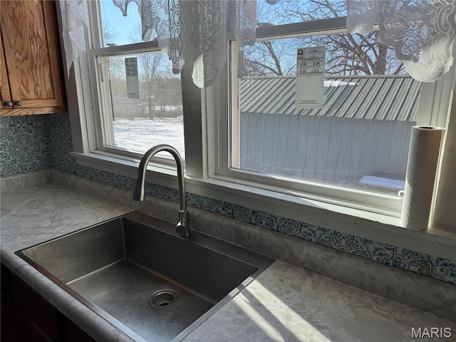 801 W Rolla Rd, Salem, MO 65560 - kitchen view of a sink, brown cabinets, and wallpapered walls