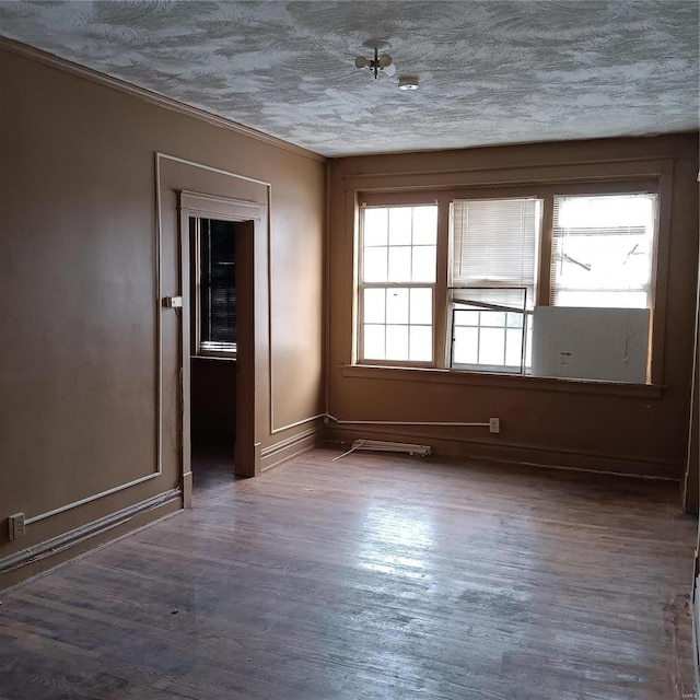 4341 Shreve Ave, Saint Louis, MO 63115 - empty room with wood finished floors, baseboards, a textured ceiling, and crown molding