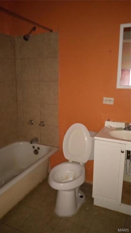 4341 Shreve Ave, Saint Louis, MO 63115 - bathroom with toilet, tile patterned flooring, vanity, and shower / washtub combination