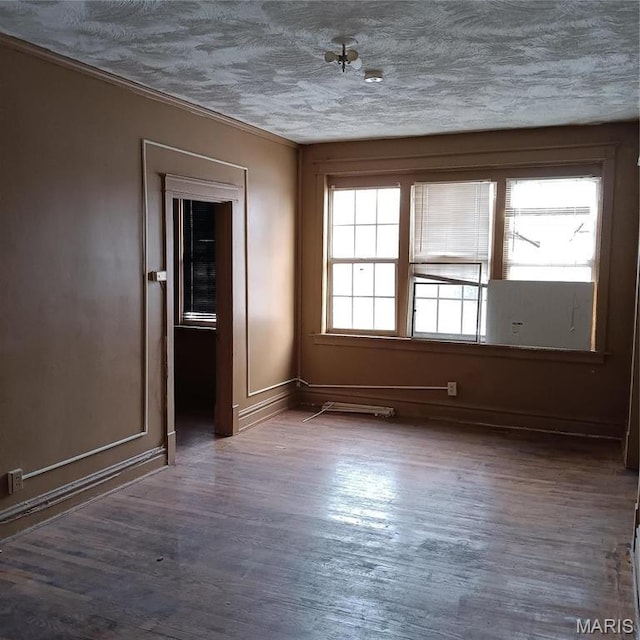 4341 Shreve Ave, Saint Louis, MO 63115 - unfurnished room featuring wood finished floors, baseboards, crown molding, and a textured ceiling
