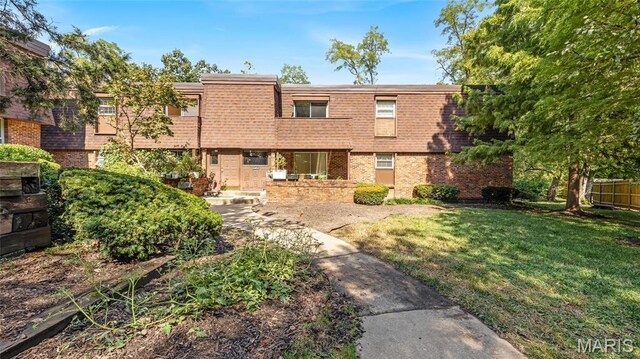 13453 Coliseum Dr Unit E, Chesterfield, MO 63017 - view of front of property featuring a front yard, brick siding, and mansard roof