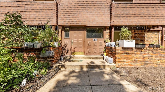 13453 Coliseum Dr Unit E, Chesterfield, MO 63017 - doorway to property featuring roof with shingles