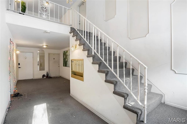 13453 Coliseum Dr Unit E, Chesterfield, MO 63017 - stairs with carpet, baseboards, and a towering ceiling