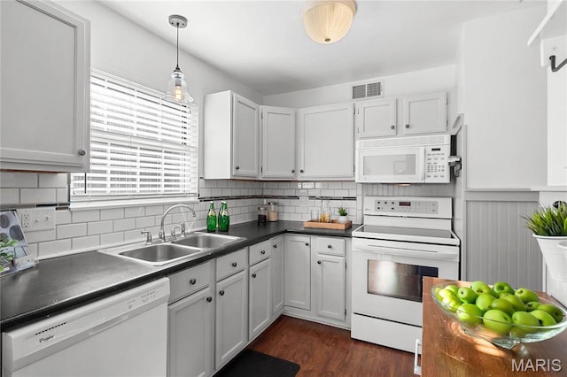 13453 Coliseum Dr Unit E, Chesterfield, MO 63017 - kitchen with white appliances, a sink, dark countertops, dark wood-style flooring, and backsplash