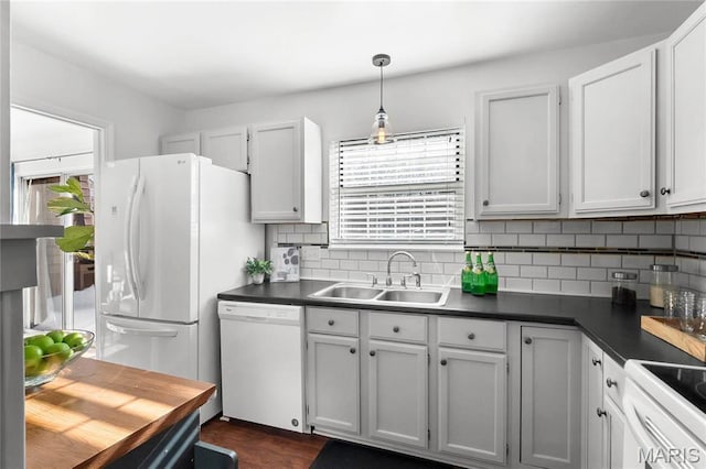 13453 Coliseum Dr Unit E, Chesterfield, MO 63017 - kitchen with white appliances, a sink, dark countertops, and tasteful backsplash