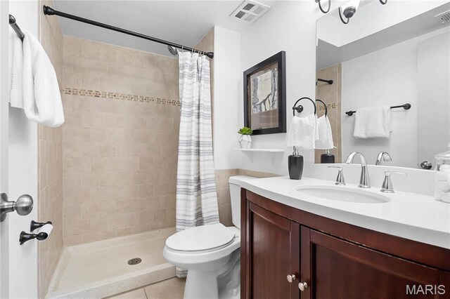 13453 Coliseum Dr Unit E, Chesterfield, MO 63017 - bathroom featuring tile patterned floors, a shower stall, vanity, and toilet