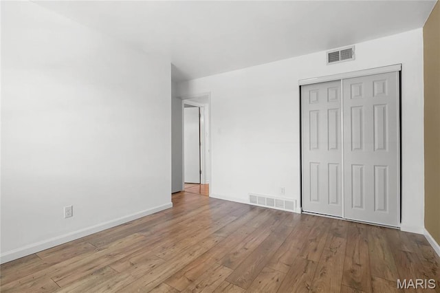 13453 Coliseum Dr Unit E, Chesterfield, MO 63017 - unfurnished bedroom featuring hardwood / wood-style flooring, a closet, and baseboards