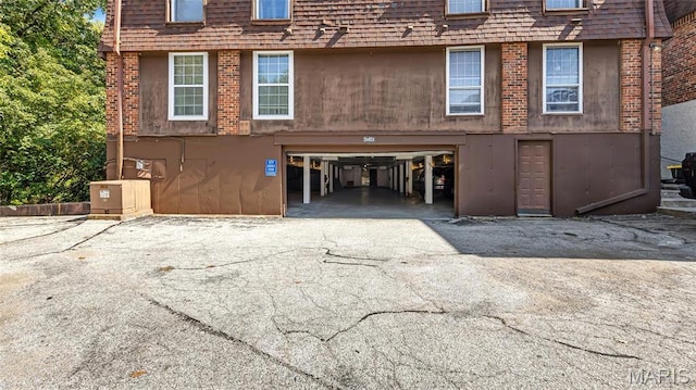 13453 Coliseum Dr Unit E, Chesterfield, MO 63017 - view of front of house with an attached garage, driveway, and mansard roof