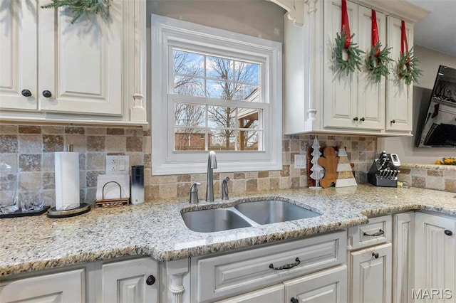 912 Westview Dr, Sikeston, MO 63801 - kitchen with white cabinetry, a sink, and tasteful backsplash