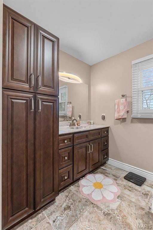 912 Westview Dr, Sikeston, MO 63801 - bathroom with baseboards, marble finish floors, and vanity