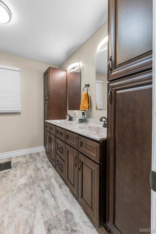 912 Westview Dr, Sikeston, MO 63801 - bathroom with baseboards and double vanity