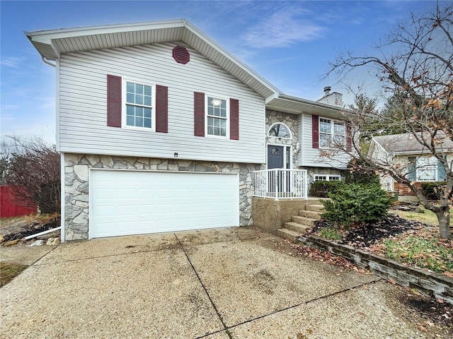 1253 Orion Way, Saint Peters, MO 63376 - split foyer home featuring stone siding, an attached garage, driveway, and a chimney