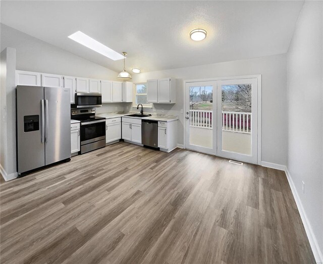 1253 Orion Way, Saint Peters, MO 63376 - kitchen featuring appliances with stainless steel finishes, a sink, lofted ceiling, light countertops, and a skylight