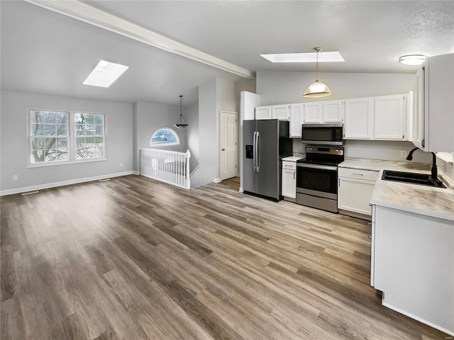 1253 Orion Way, Saint Peters, MO 63376 - kitchen featuring a skylight, stainless steel appliances, a sink, light countertops, and white cabinetry