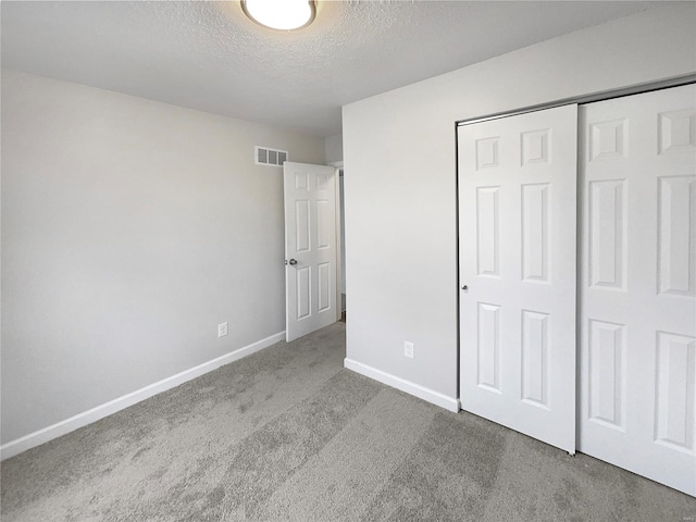 1253 Orion Way, Saint Peters, MO 63376 - unfurnished bedroom with carpet flooring, a textured ceiling, baseboards, and a closet