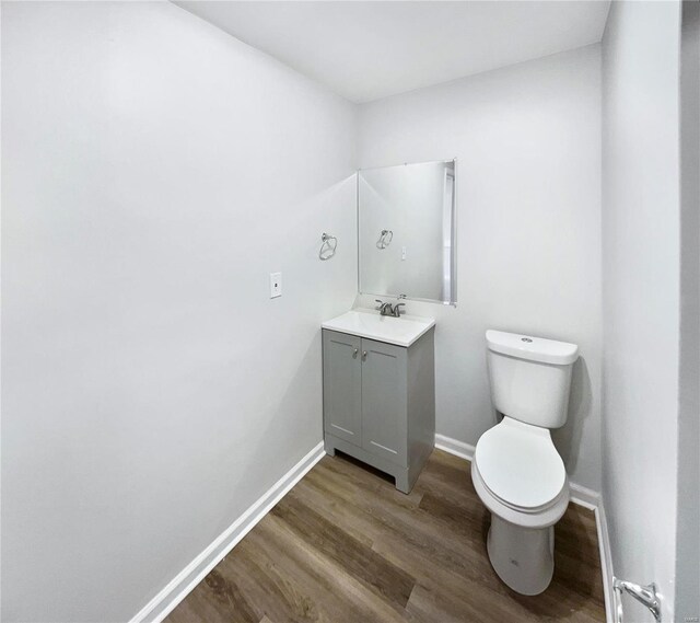 1253 Orion Way, Saint Peters, MO 63376 - half bathroom featuring wood finished floors, toilet, baseboards, and vanity