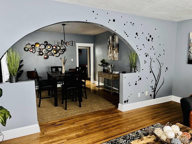 4983 Chippewa St, Saint Louis, MO 63109 - dining room with wood finished floors, arched walkways, and baseboards