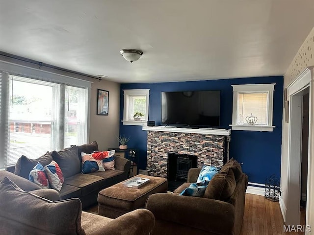 4983 Chippewa St, Saint Louis, MO 63109 - living room with wood finished floors, a stone fireplace, and baseboards