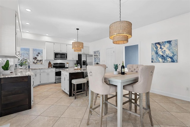 dining area featuring light tile patterned flooring, recessed lighting, and baseboards